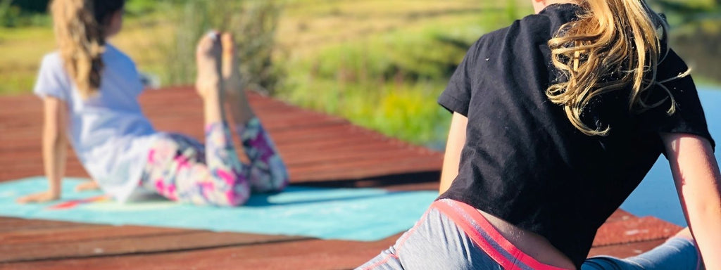 Girls practicing yoga outside 